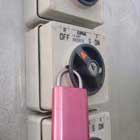 Pink padlock on light switch