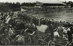 Early black and white image of Kardinia Park with crowds watching the game from horse and buggies