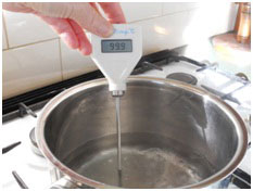 Hot temperature test - image shows thermometer in a saucepan of hot water