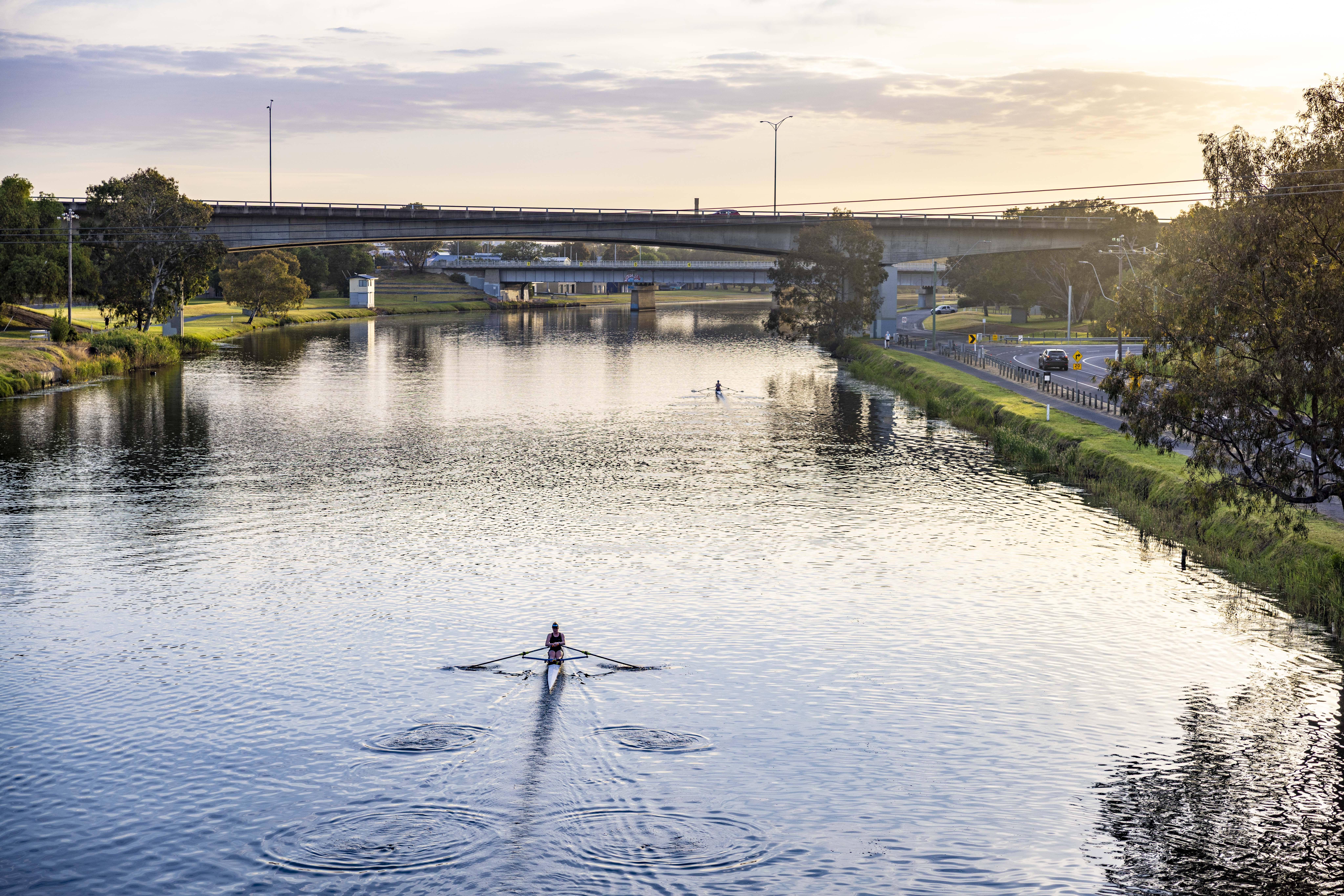 Bridge over the Barwon River with a single rower on the water