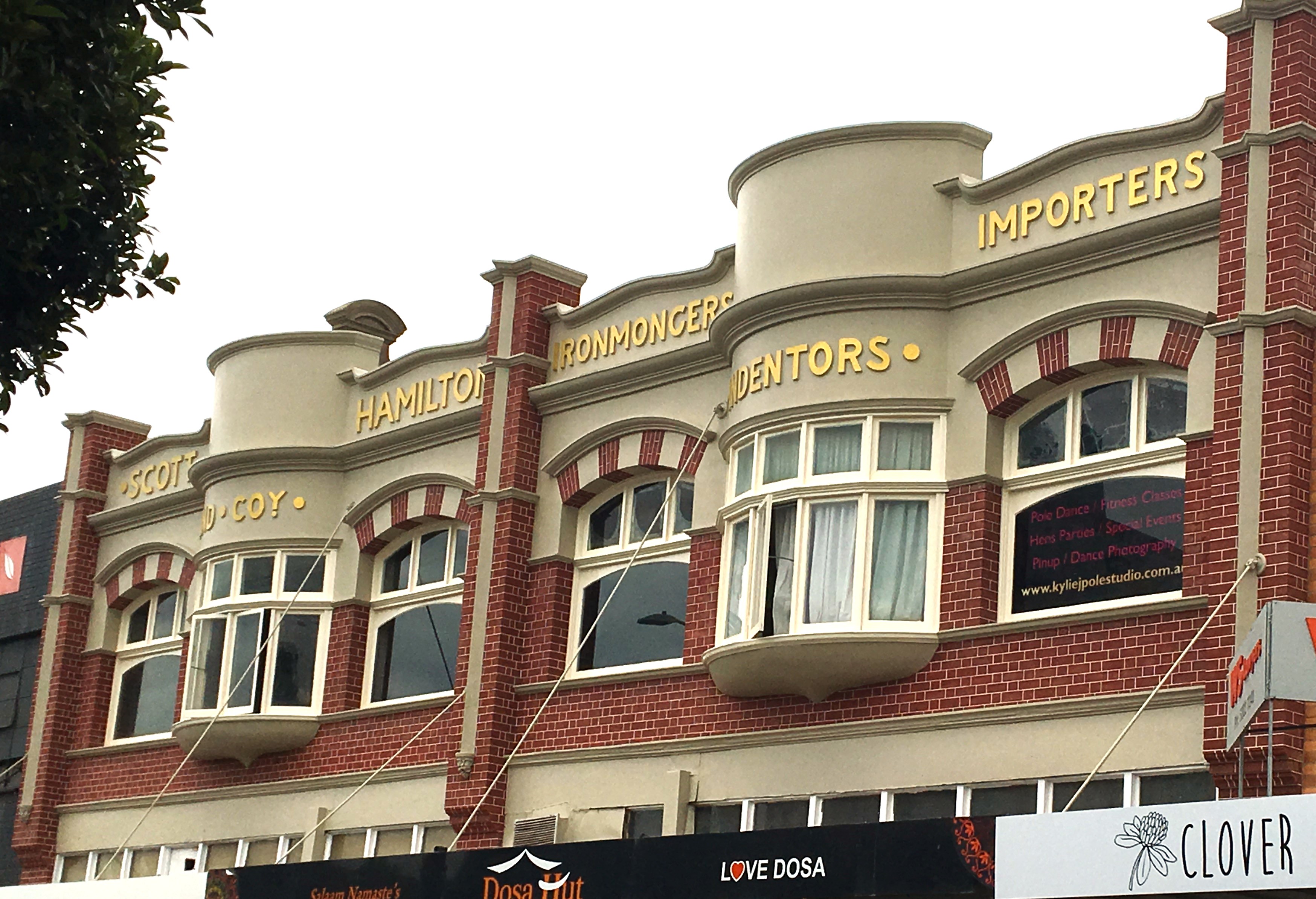 Redbrick facade of Federation Freestyle building with white trimmed windows and gold letters across the top