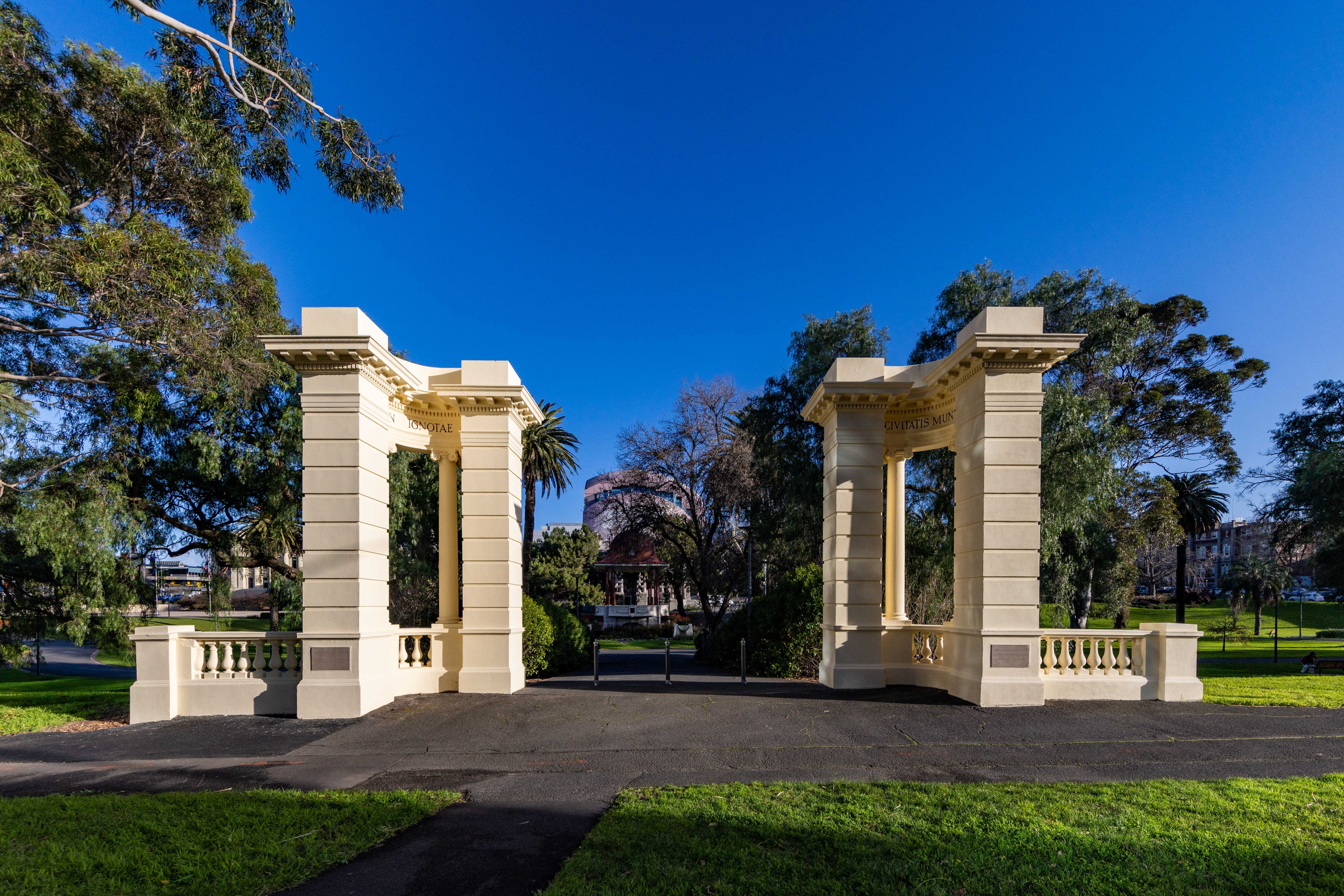 Cream coloured architectural designed heritage listed gates at the front of Johnston Park.