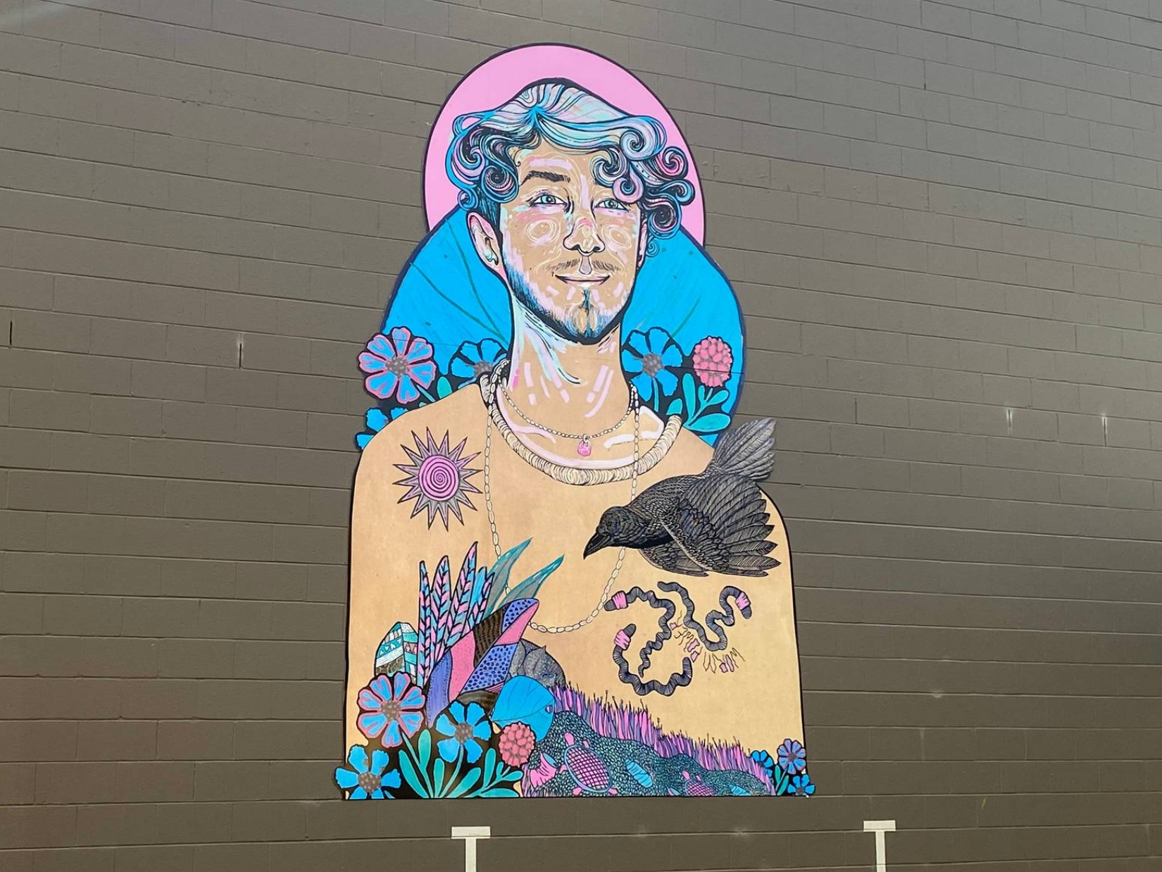 Colourful paste up of a young person surrounded by plants, flowers, and a bird
