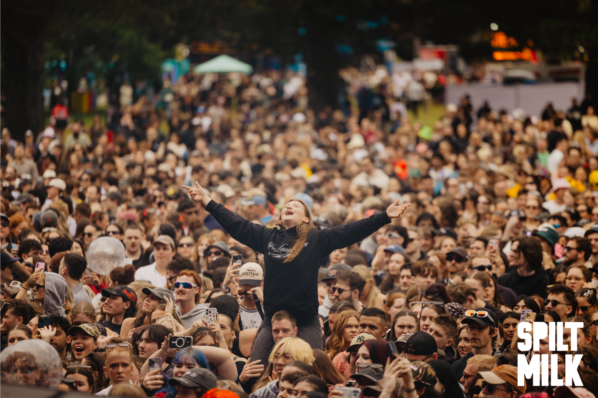 Crowd of people smiling and watching a performance
