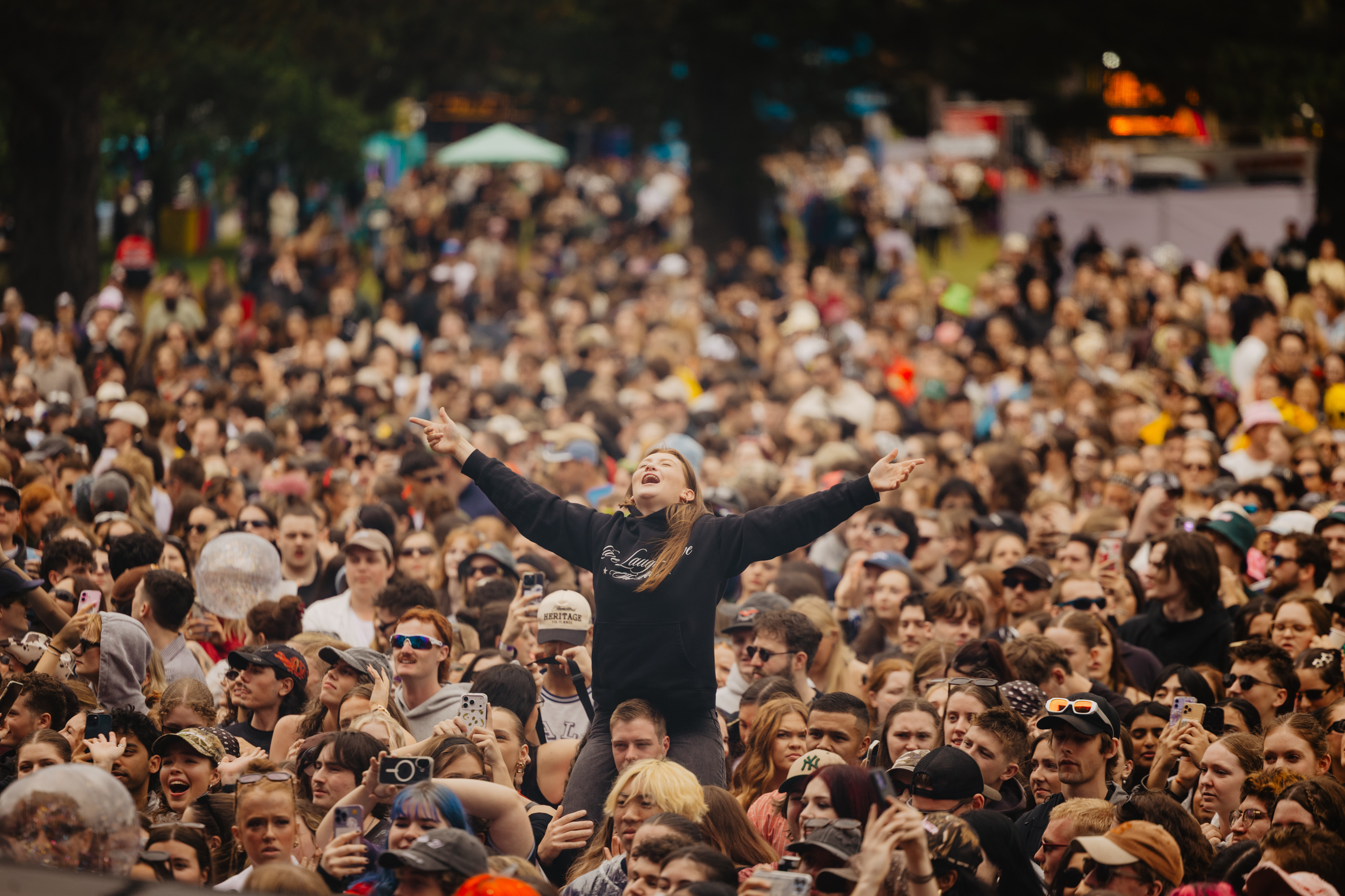 A crowd of people listening to music