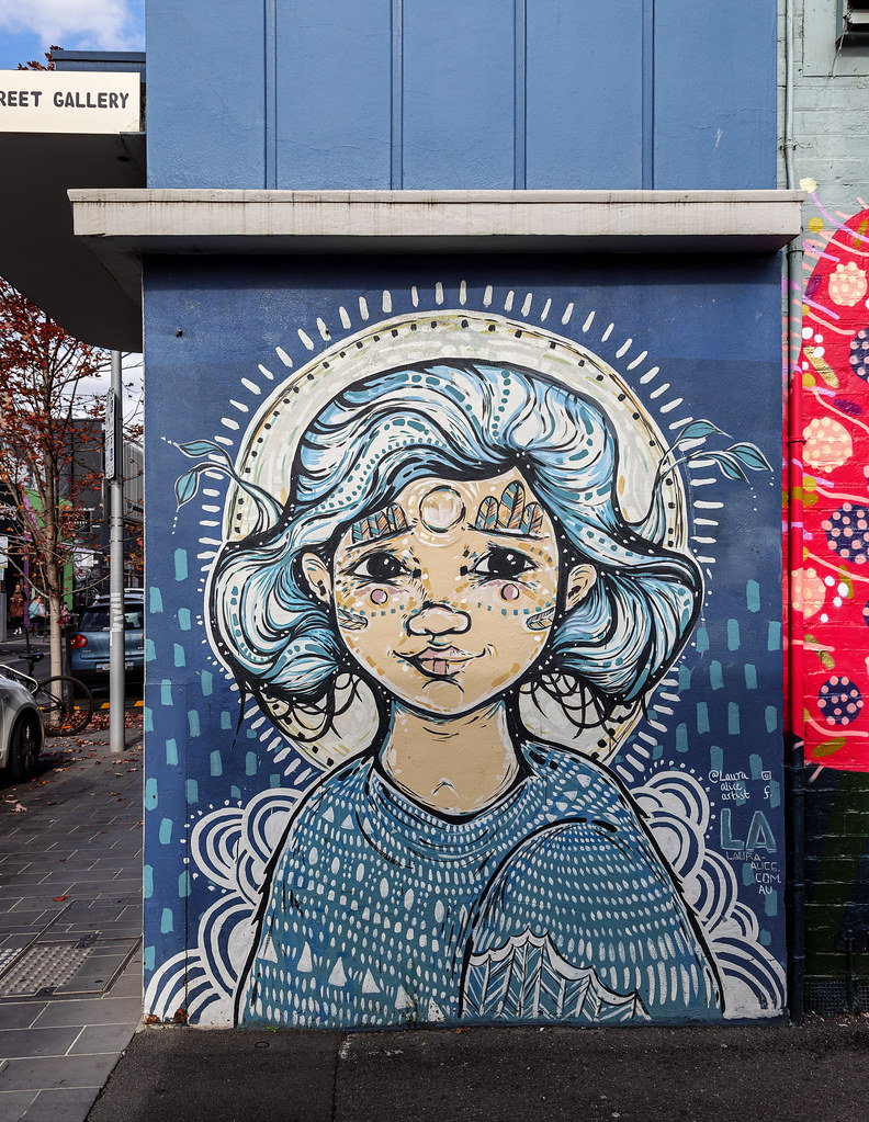 Colourful paste up a young girl with flowing hair and a bird wing