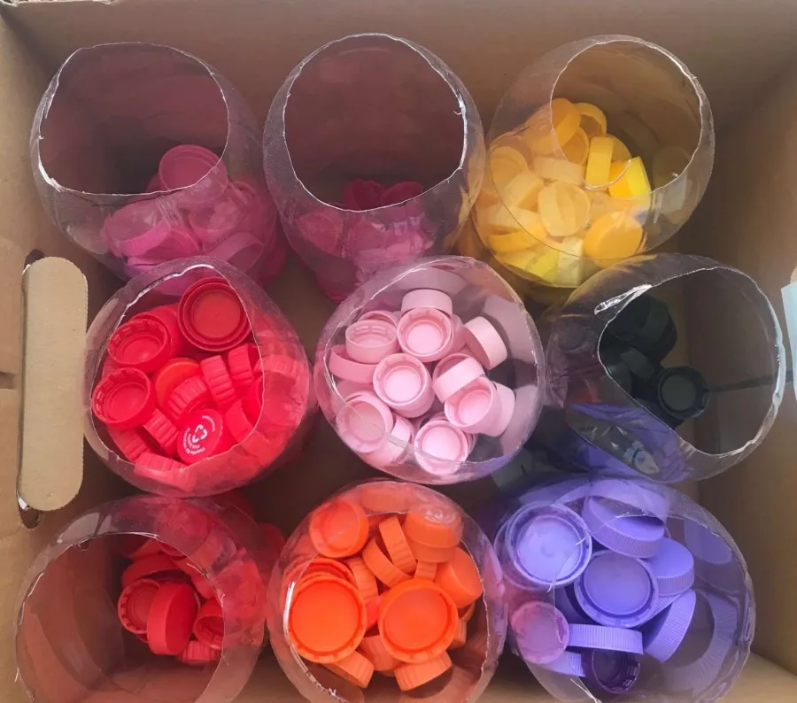 Plastic lids that have been cleaned, dried and sorted, ready for recycling. 