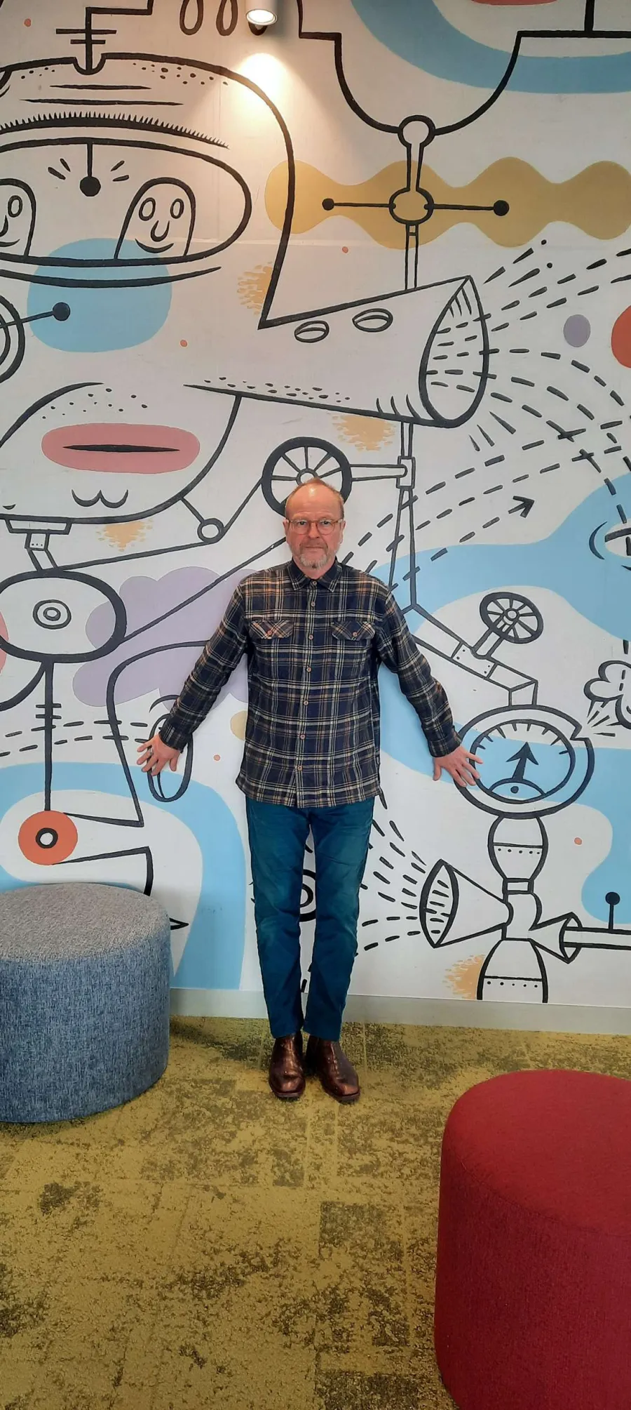 Artist Jeff Raglus with his mural