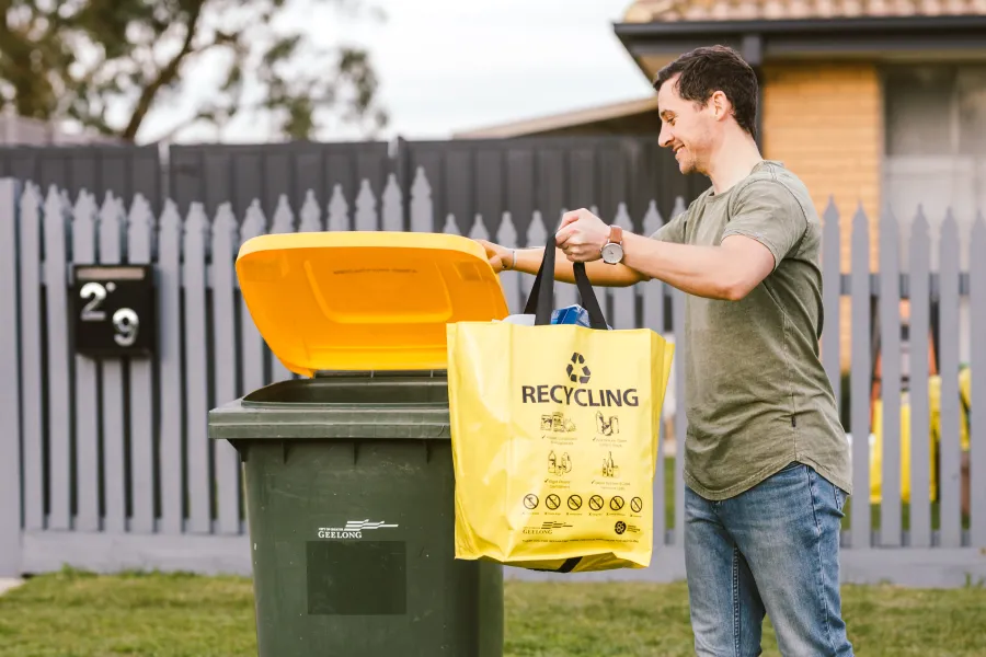 0927_Katherine and Zac_Waste_by HandZaround Video Photography.jpg Man taking recycling to the bin using a bag.