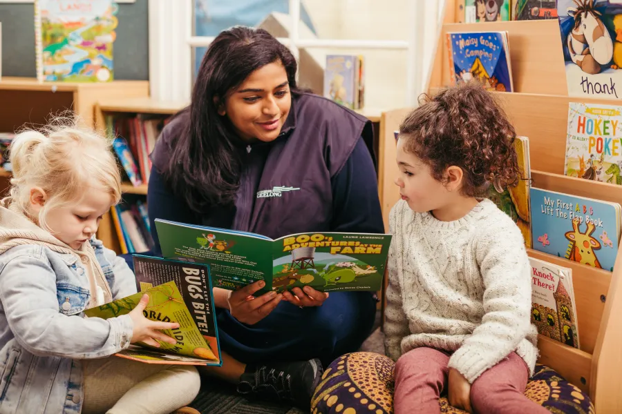 Educator reading to child at Early Childhood education centre.