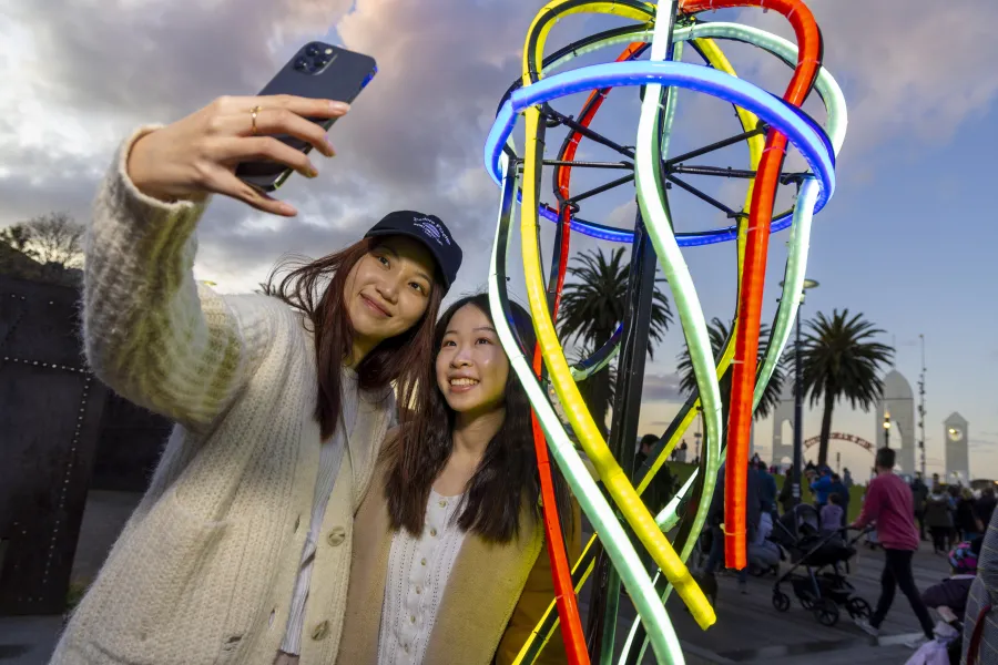 WhiteNight_UnderTheNeonSea-2433.jpg Two women taking a selfie at Cunningham Pier during White Night event.