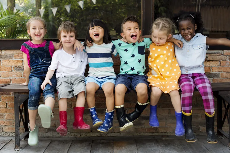 kindergartens.jpeg Group of kindergarten kids friends sitting and smiling
