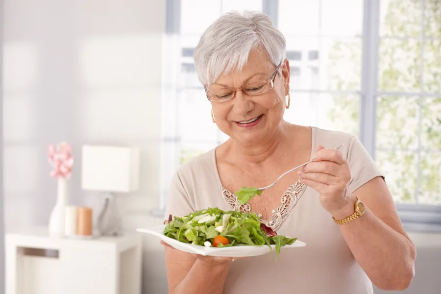Happy lady eating fresh meal.