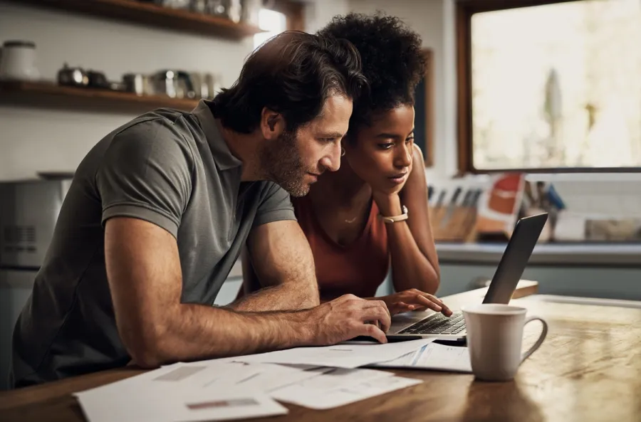 Couple looking at rates on laptop