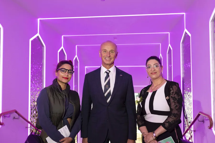 Mayor standing with two guests