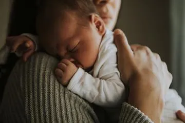 Baby on mother's shoulder Baby on mother's shoulder