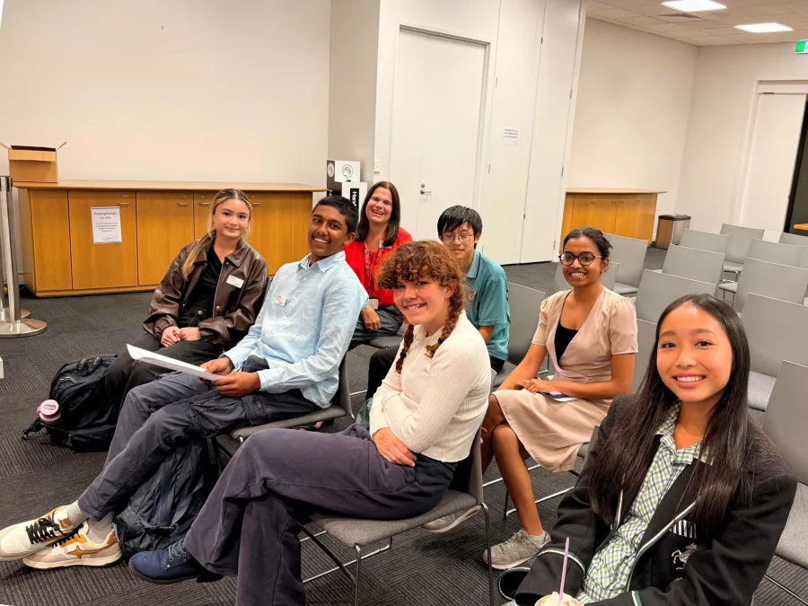 Young people sitting down and smiling