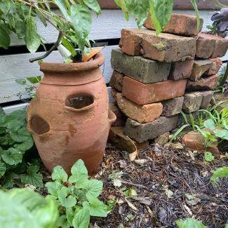 Broken pots and bricks in a garden to create havens for wildlife