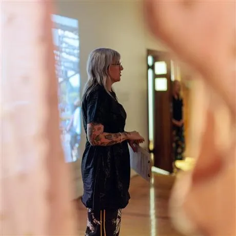Lady standing looking at an image