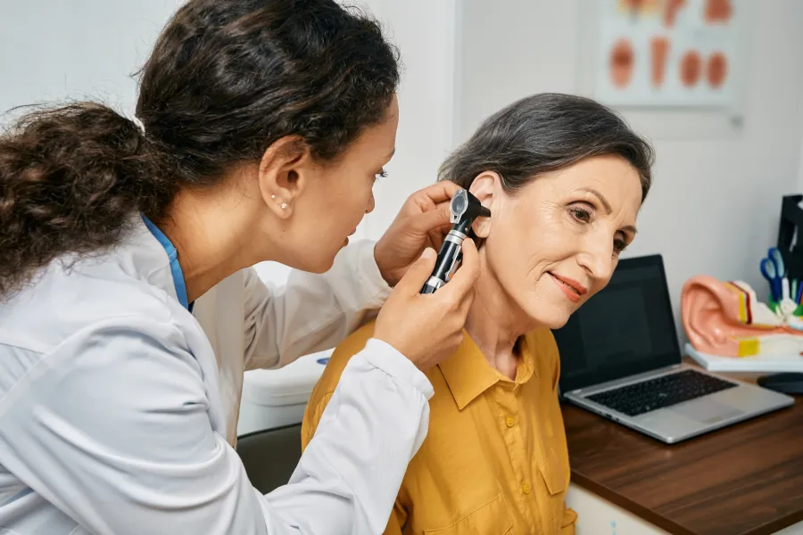 Lady conducting an ear check