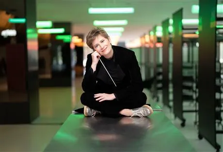 Image of lady in black sitting crossed leg