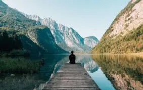 person sitting at end of pier