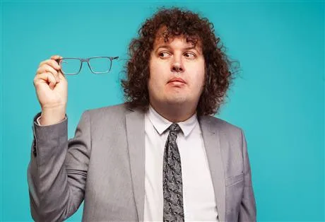 Image of Ray O'Leary holding is glasses to the side