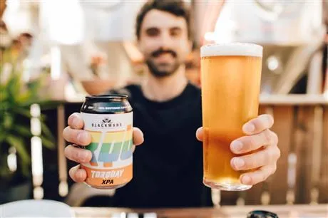 Image of a man holding a beer