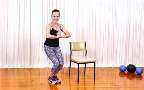 image of lady squatting beside chair