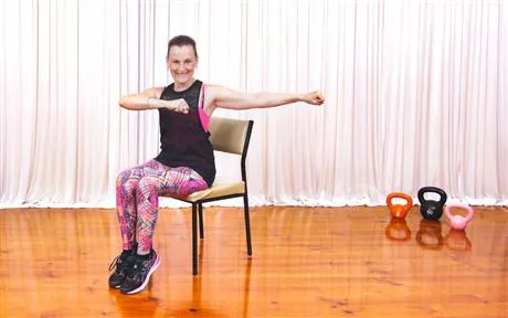 Image of lady sitting on chair exercising