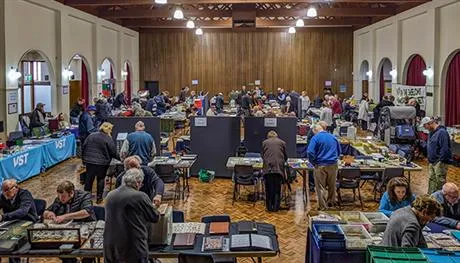 Image of stamp and coin fair with people looking