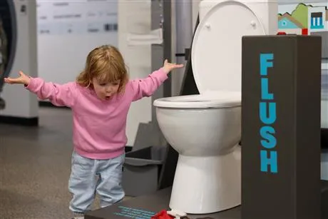 girl standing beside toilet