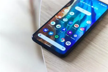 Mobile phone on table with apps showing on home screen
