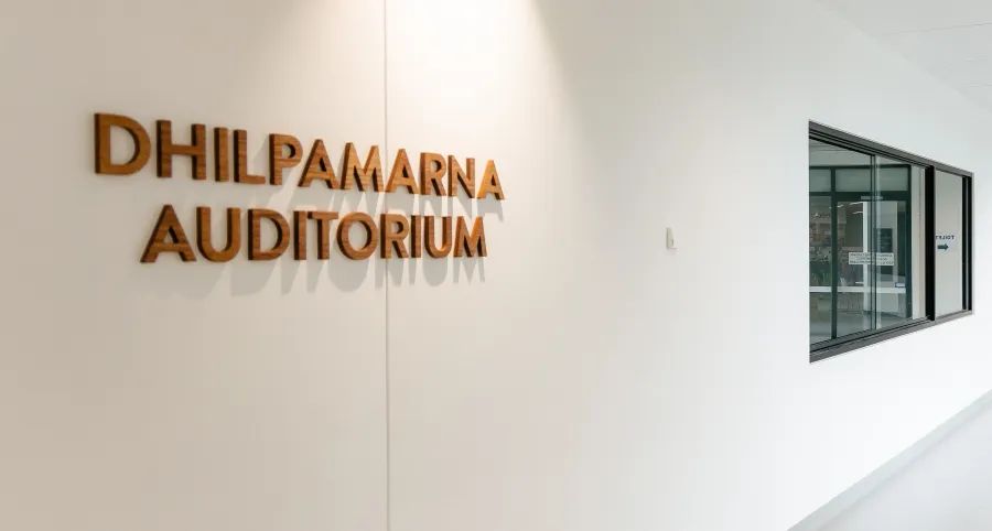 Timber lettering spells out Dhilpamarna Auditorium