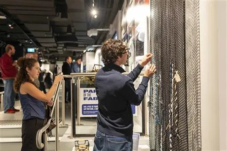 Image of people looking at display