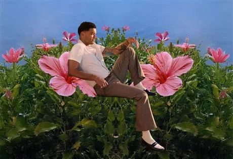 Image of Guy Sebastian sitting on flowers
