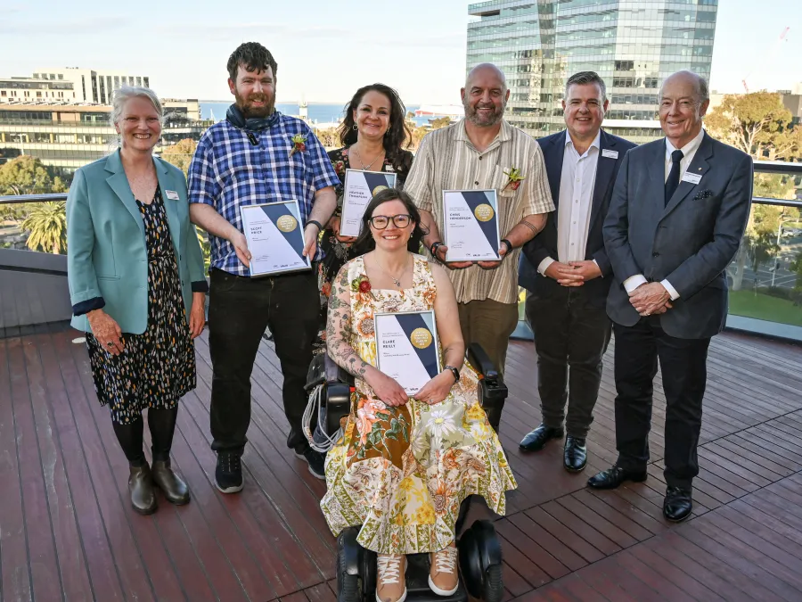 2025 Geelong Awards for People with Disability winners and Counsillors 6 people standing, one wheelchair user. Three Councillors and four award winners holding certificates