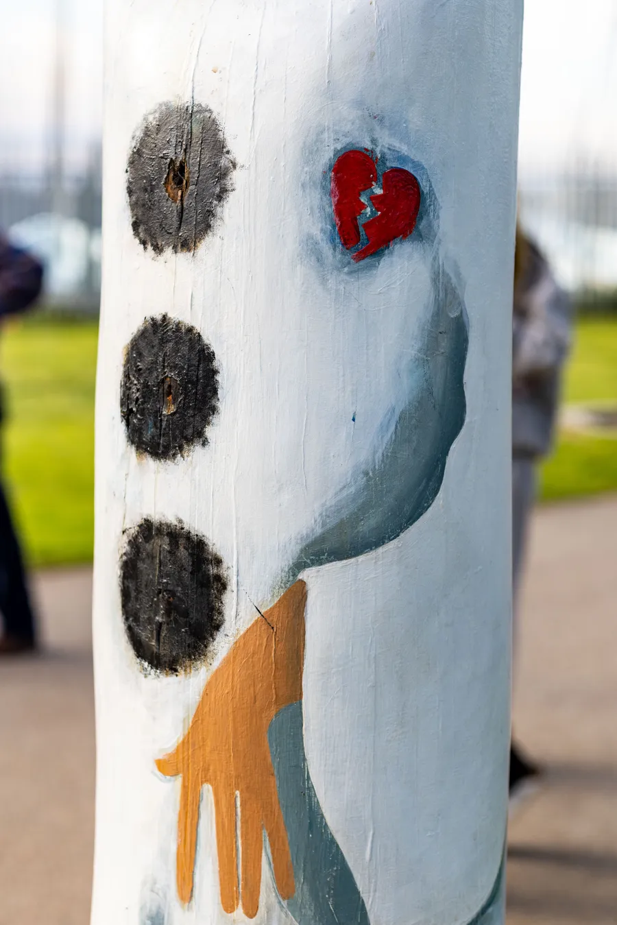 Painted broken heart brooch on bollard