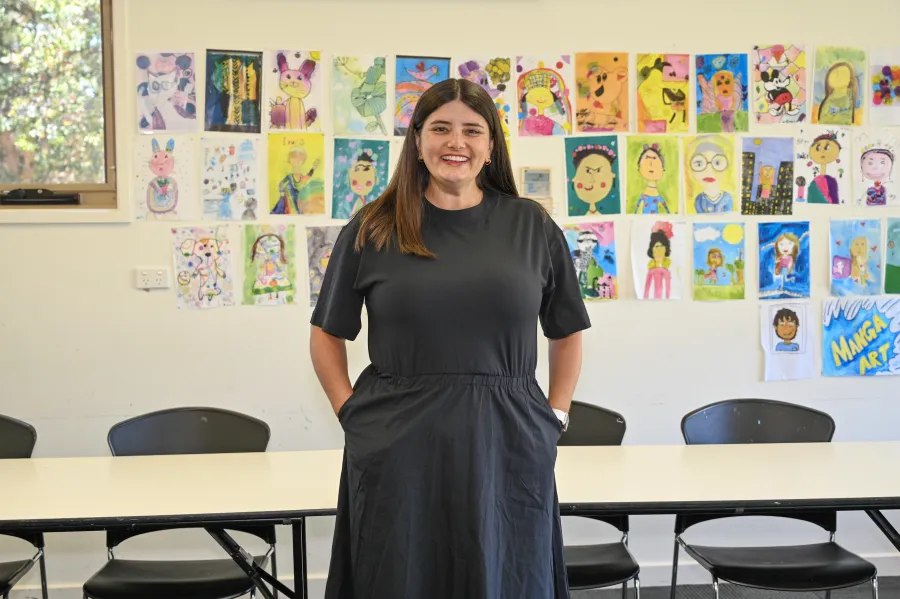 Beth Van Elst artist art teacher in front of artwork