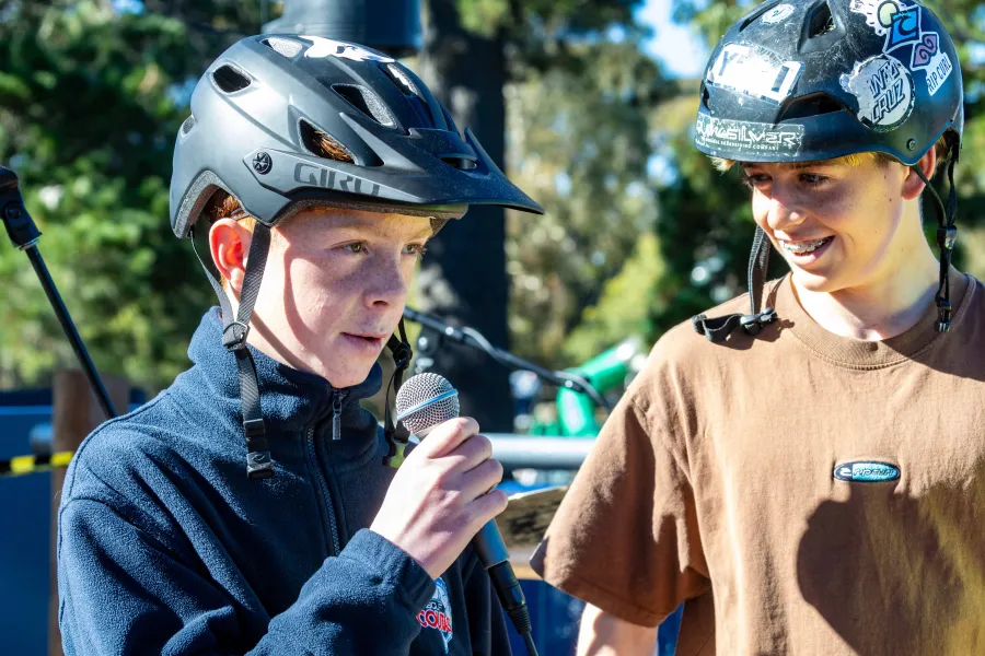 One of two young boys speaking on the microphone
