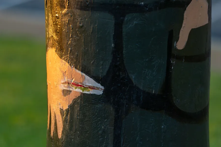 Painted small sandwich held by bollard