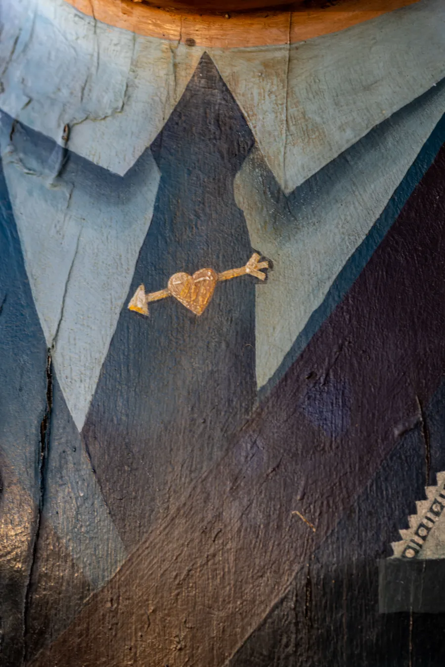 Golden heart and arrow tie pin painted on bollard