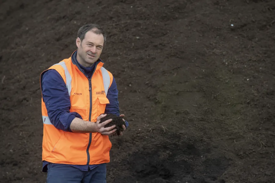 Composting expert Andrew holds up a handful of compost from our Anakie processing facility