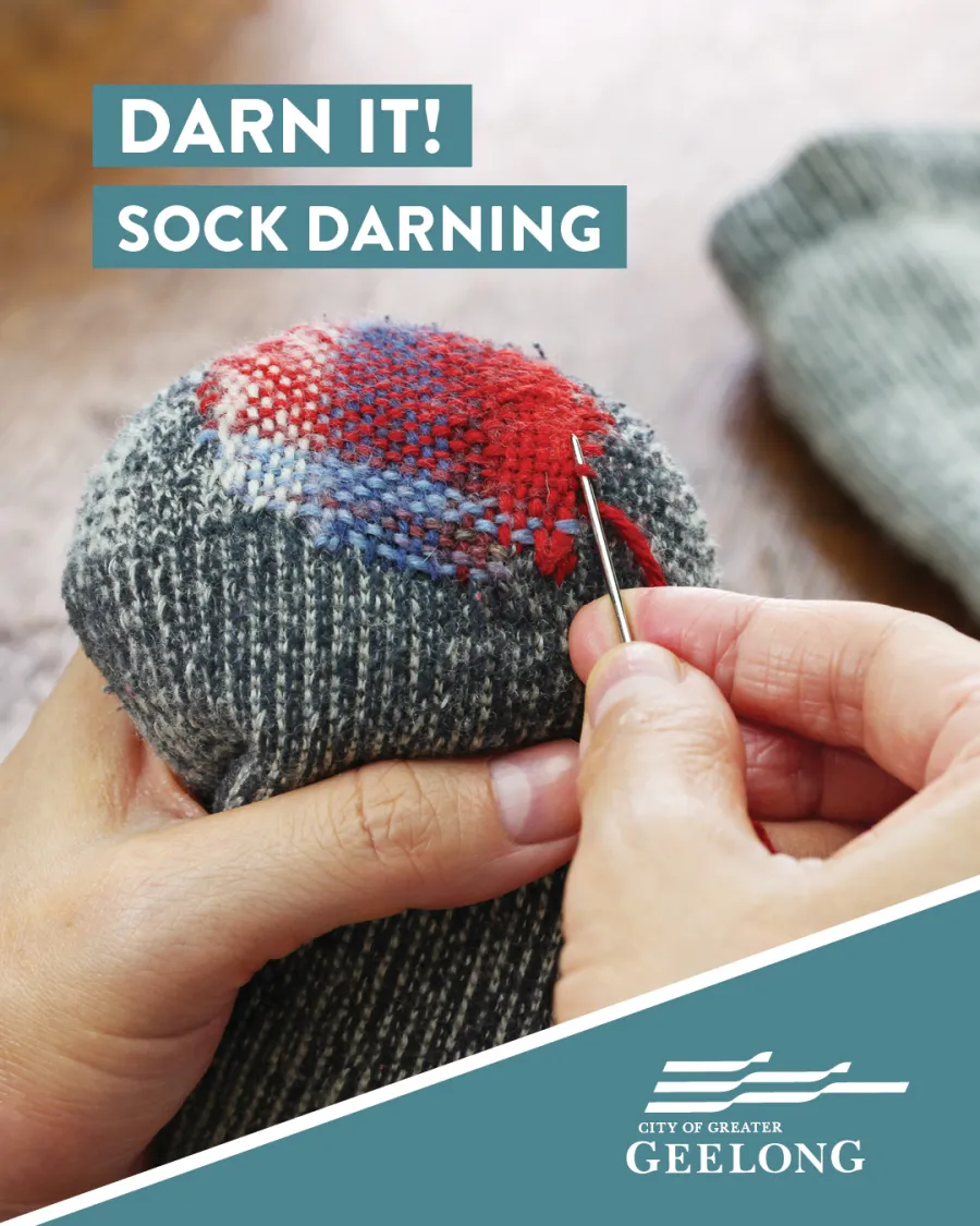 person with needle and thread repairing a sock
