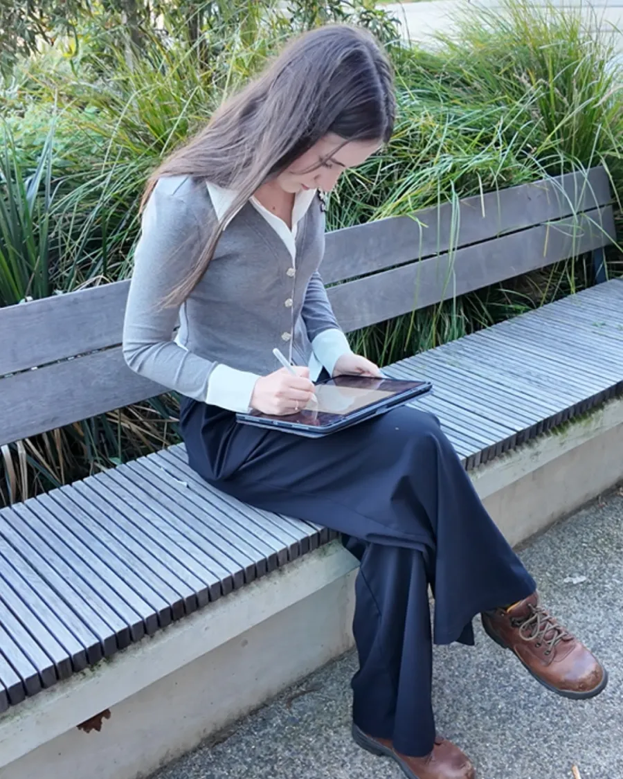 Young person sitting and drawing