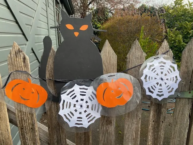 Crafted Halloween decorations Image of home-made Halloween decorations including a cat, pumpkins and spider webs..