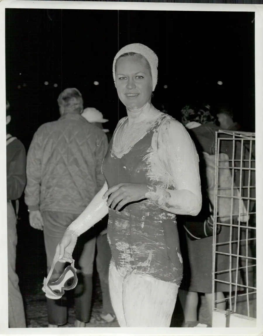 Woman standing next to shark cage