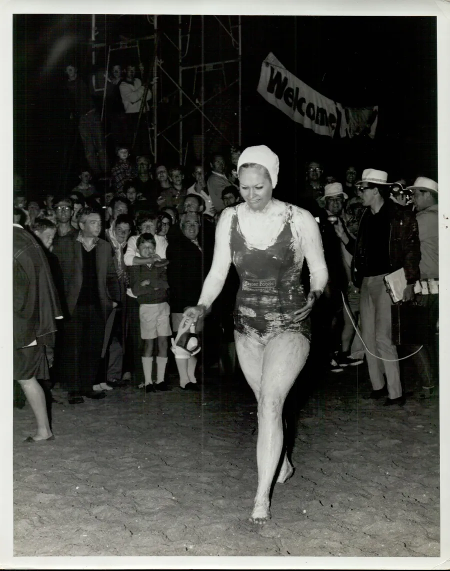 Woman walking with well wishers behind her