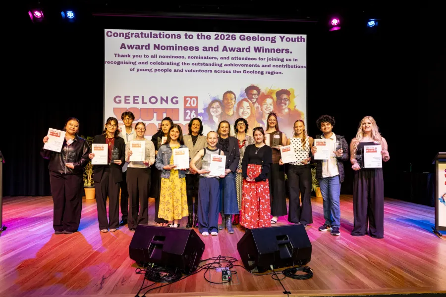 Winners with Councillors Sinclair and Cadwell and Christine Couzens MP. Credit - Lucinda Goodwin. Young people and adults standing on a stage smiling.
