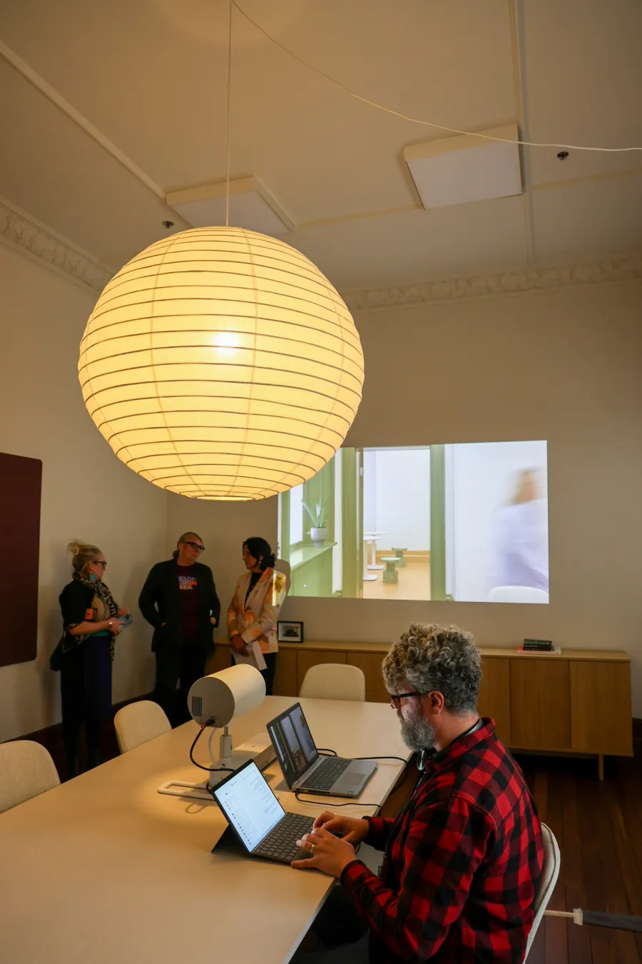 People talking or working on a laptop